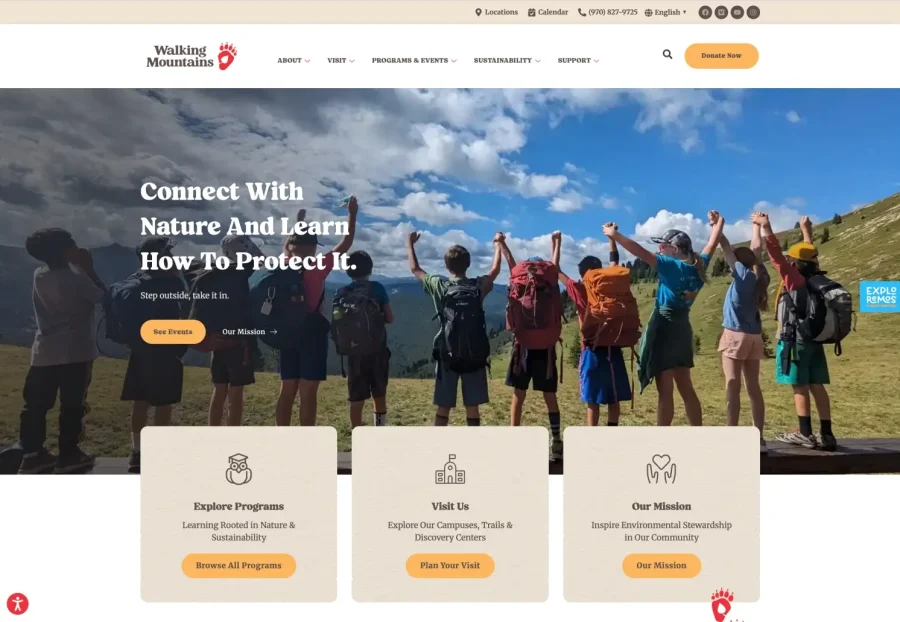 A group of people with backpacks stand on a grassy hilltop, raising their arms in celebration, facing a scenic mountain landscape under a blue sky. The website promotes nature programs and environmental stewardship.